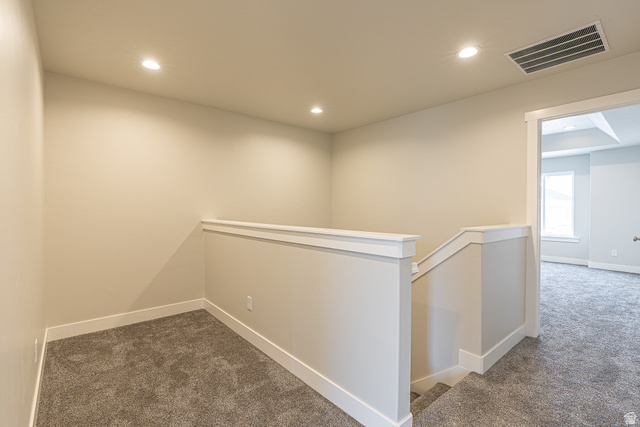 2249 South 1090 West, Unit 76 Nibley, UT 84321 - Photo 8 of 19 Carpeted landing area featuring recessed lighting, a white painted half-wall railing, and white baseboards