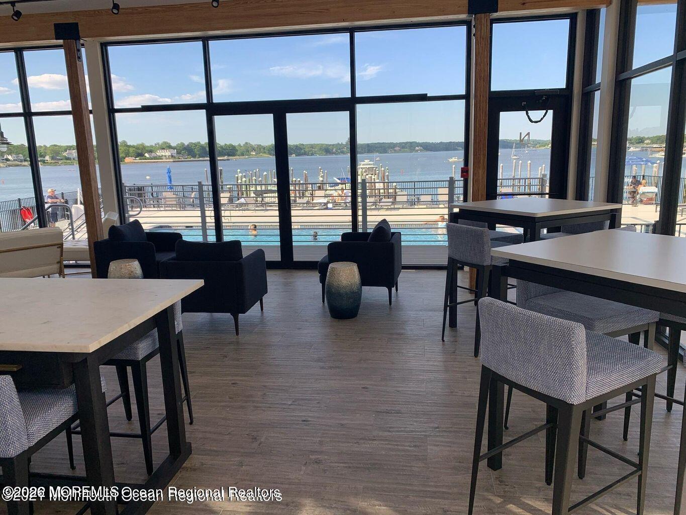 28 Riverside Avenue, Unit 10B Red Bank, NJ 07701 - Photo 22 of 24 a view of a dining room with furniture large windows and wooden floor