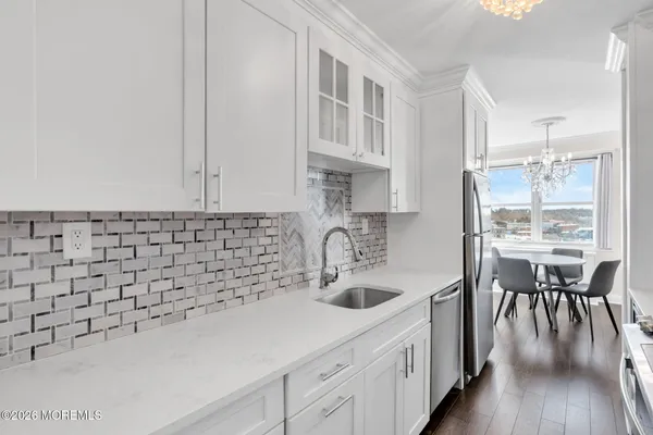 a kitchen with a sink cabinets and wooden floor