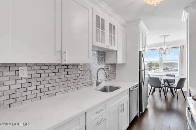 a kitchen with a sink cabinets and wooden floor