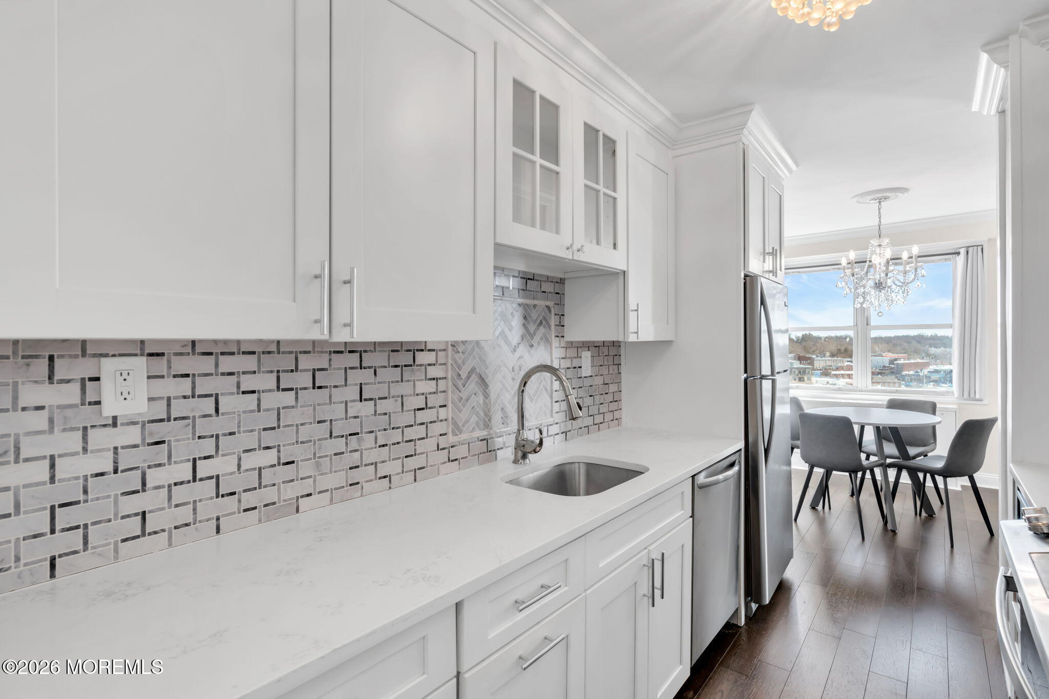 28 Riverside Avenue, Unit 10B Red Bank, NJ 07701 - Photo 3 of 24 a kitchen with a sink cabinets and wooden floor