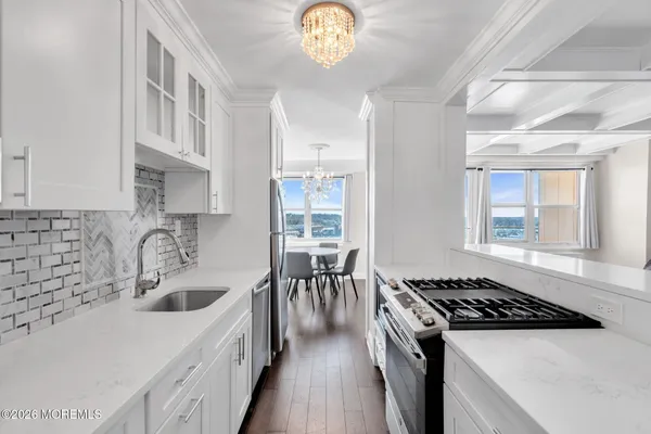 a kitchen with a stove a sink and a refrigerator