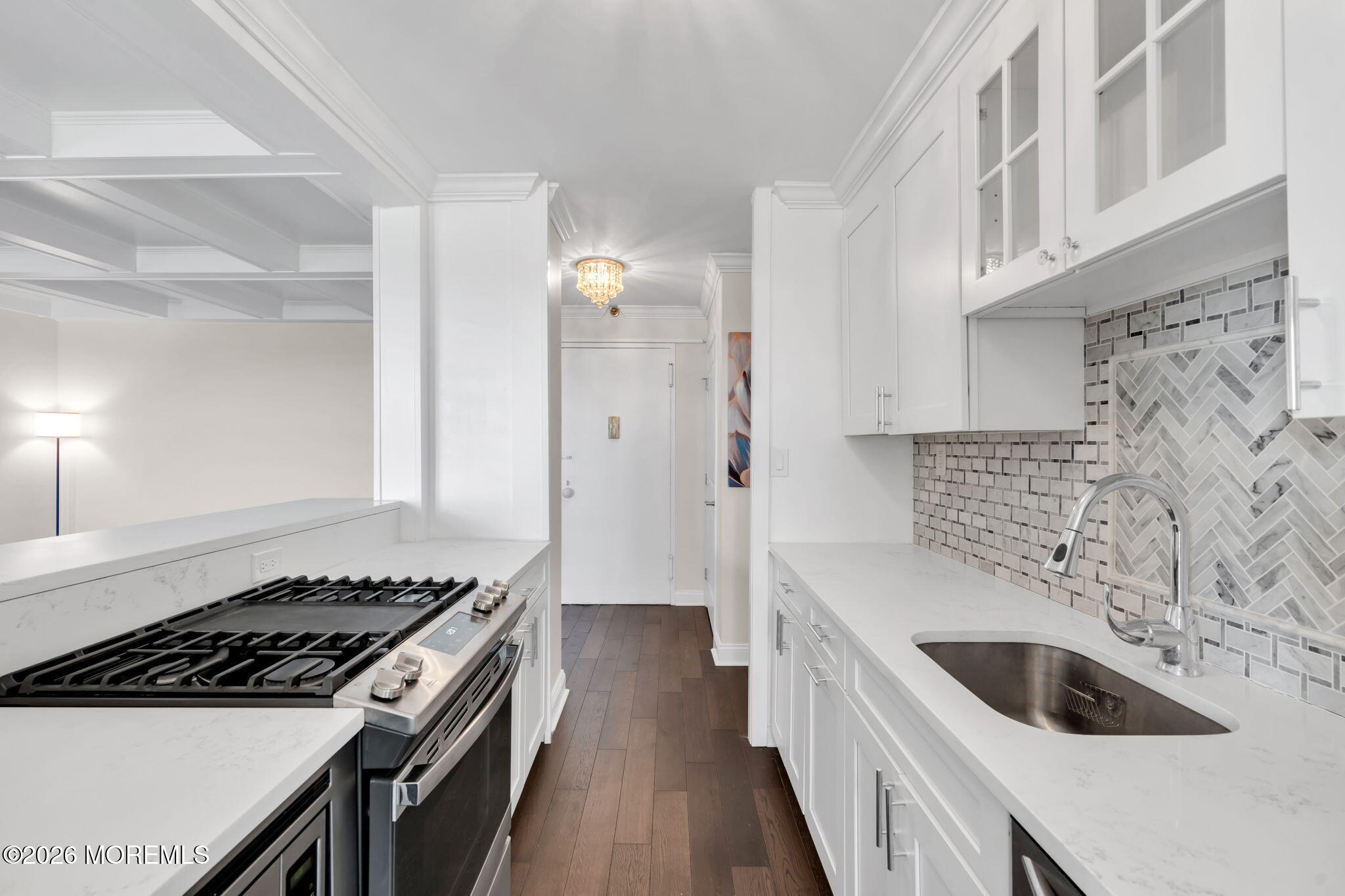 28 Riverside Avenue, Unit 10B Red Bank, NJ 07701 - Photo 5 of 24 a kitchen with granite countertop a sink stove and cabinets