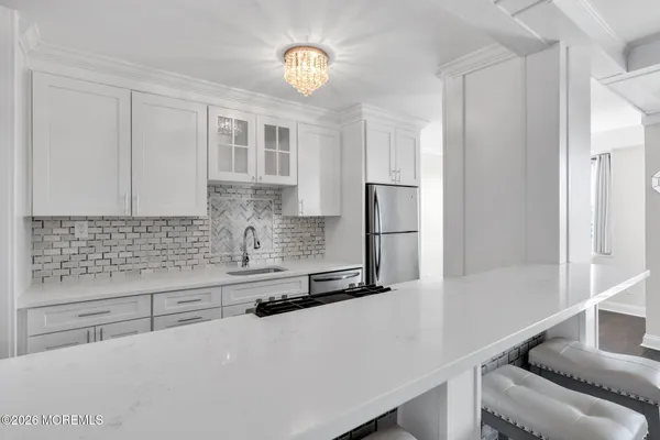 a kitchen with stainless steel appliances a refrigerator and cabinets
