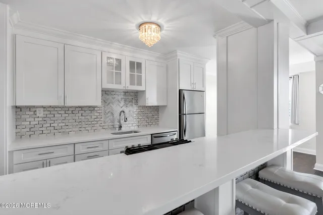 a kitchen with stainless steel appliances a refrigerator and cabinets