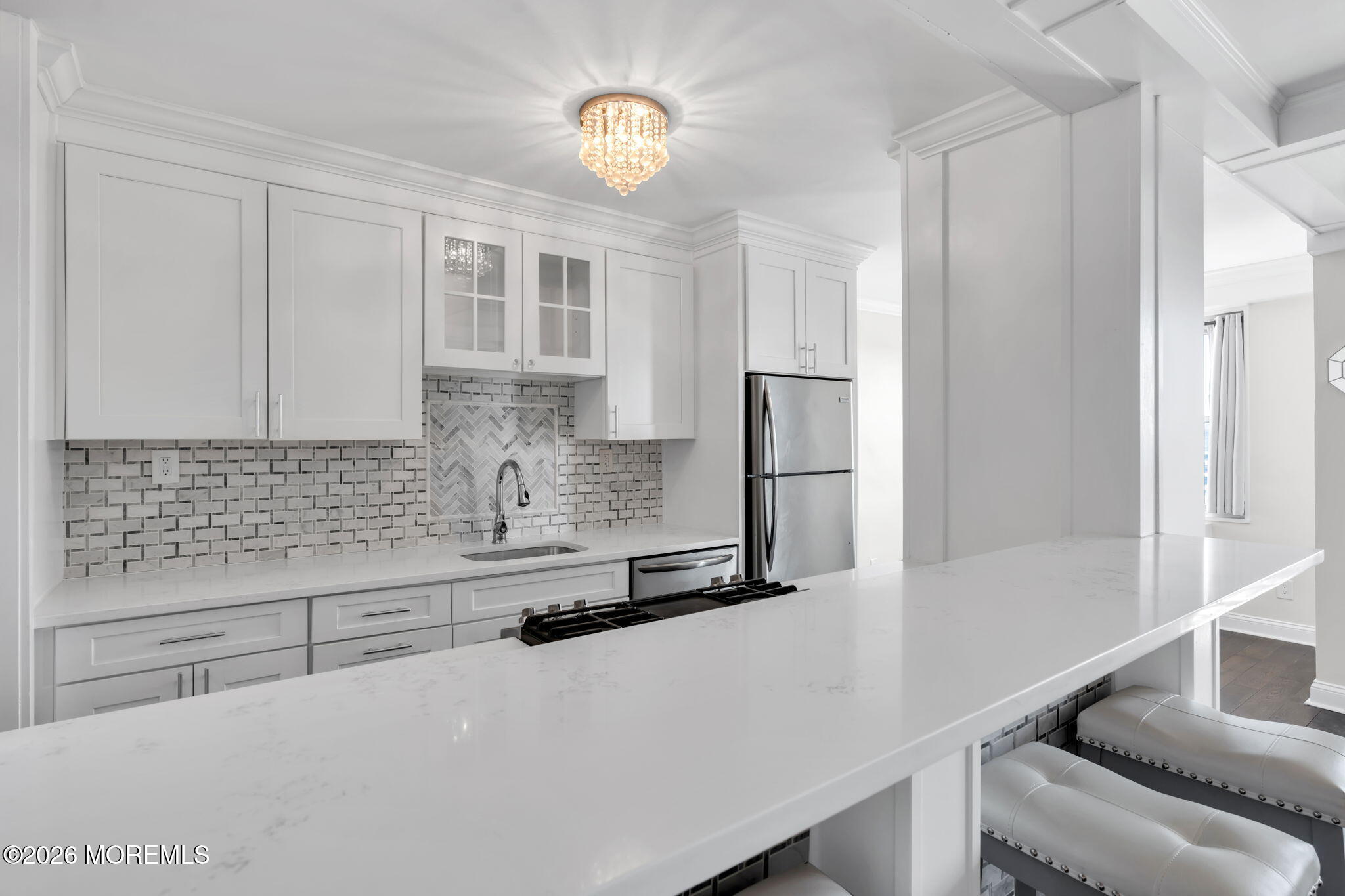 28 Riverside Avenue, Unit 10B Red Bank, NJ 07701 - Photo 8 of 24 a kitchen with stainless steel appliances a refrigerator and cabinets