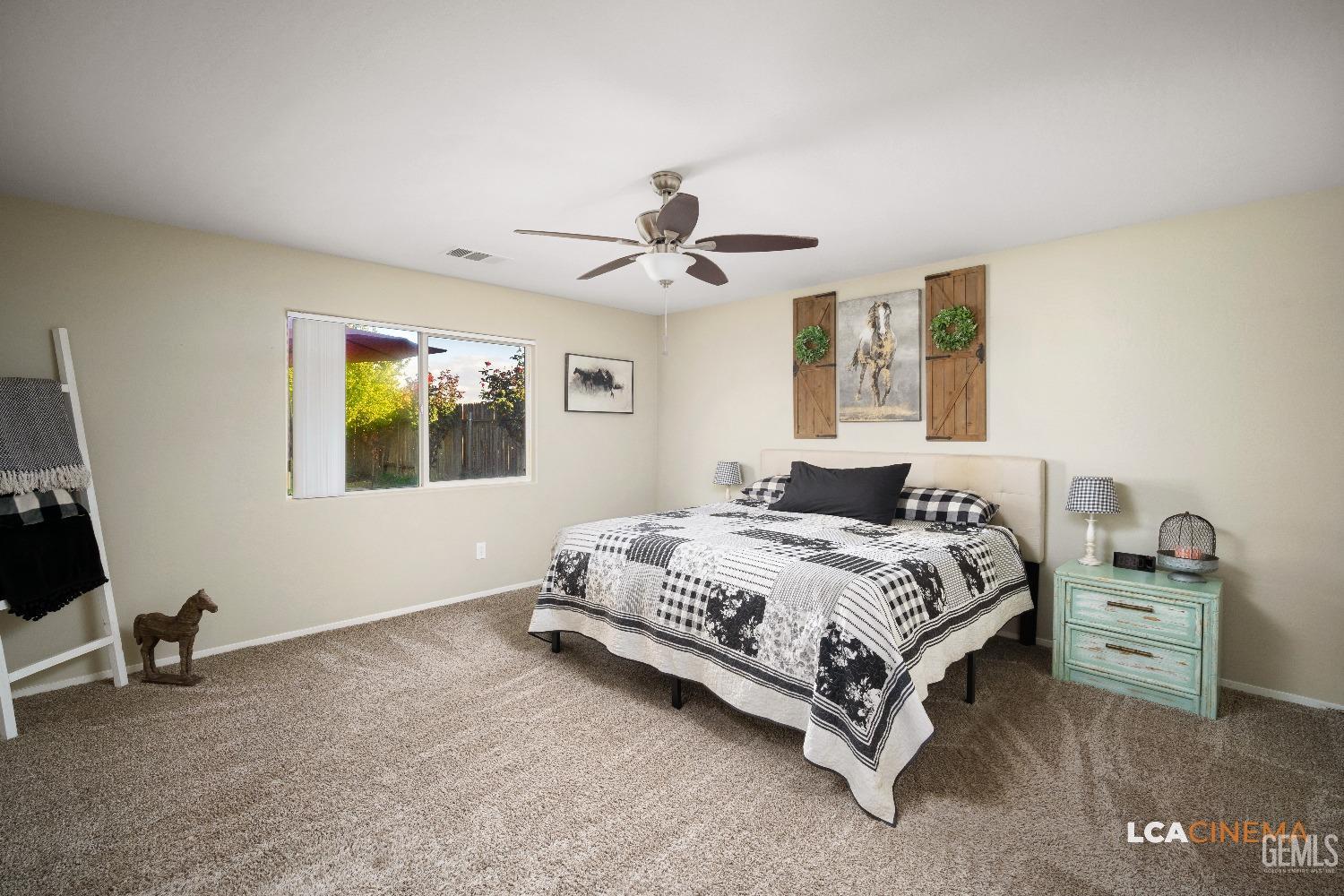 Undisclosed Address Bakersfield, CA 93311 - Photo 12 of 26 a spacious bedroom with a bed and a chandelier