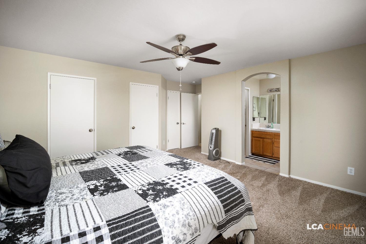 Undisclosed Address Bakersfield, CA 93311 - Photo 13 of 26 a bedroom with a bed and dresser with mirror