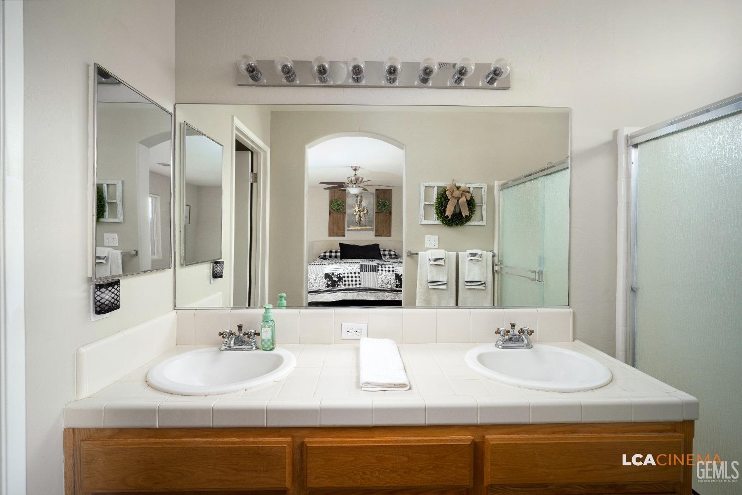 Undisclosed Address Bakersfield, CA 93311 - Photo 14 of 26 a bathroom with a sink and a mirror