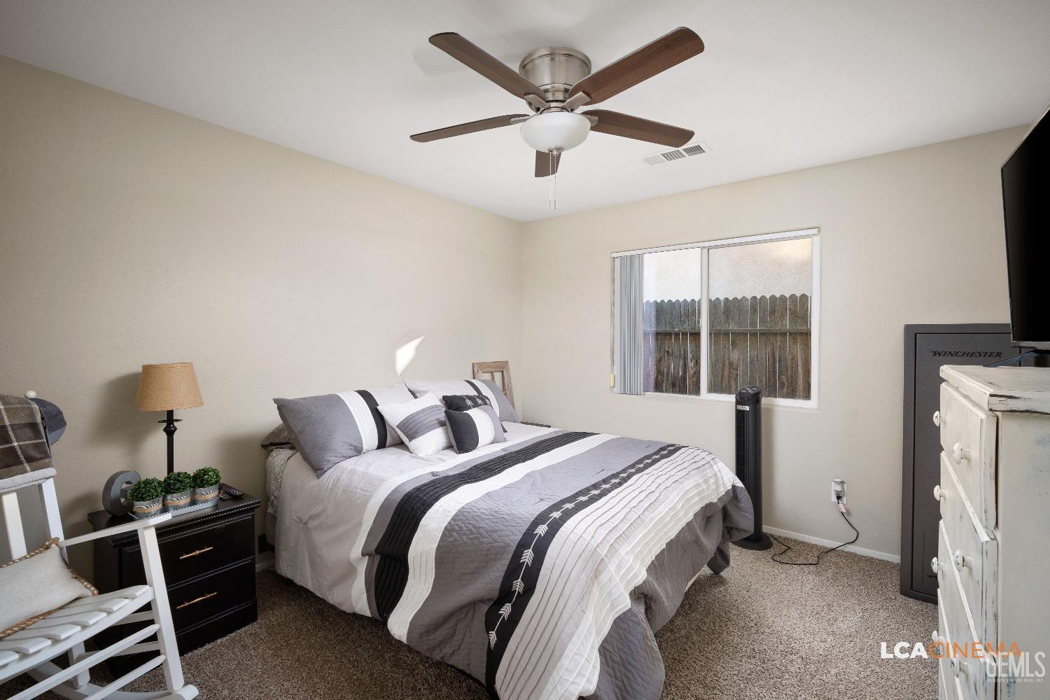 Undisclosed Address Bakersfield, CA 93311 - Photo 15 of 26 a bedroom with a bed and a flat tv screen on the dresser