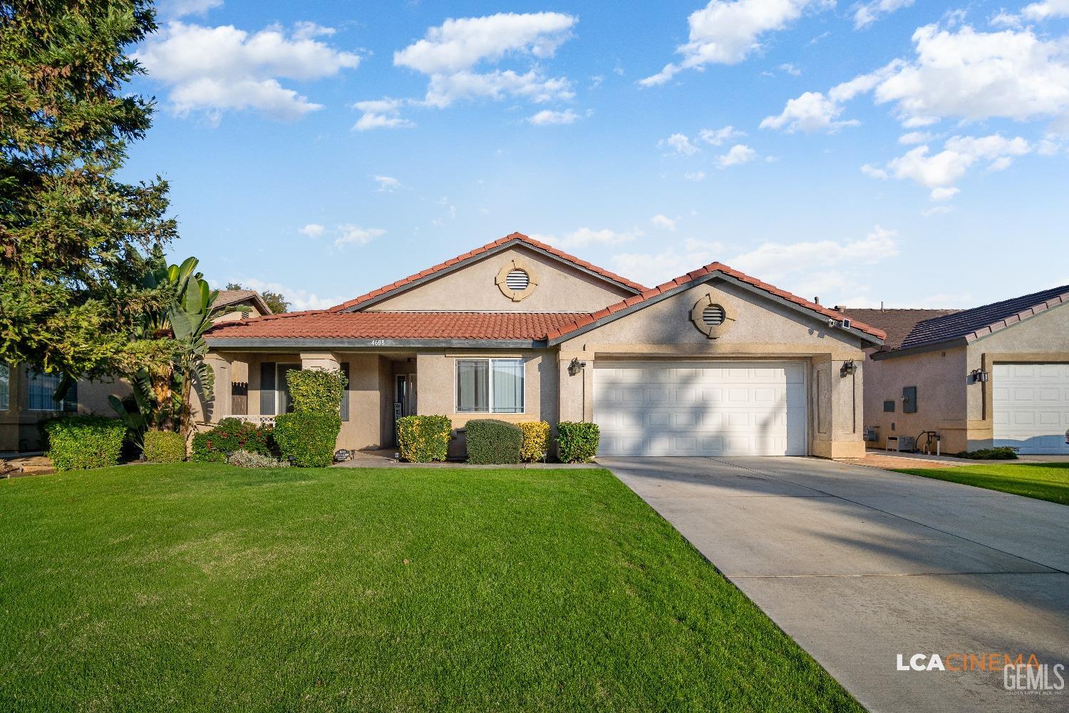 Undisclosed Address Bakersfield, CA 93311 - Photo 2 of 26 a front view of a house with a yard and garage