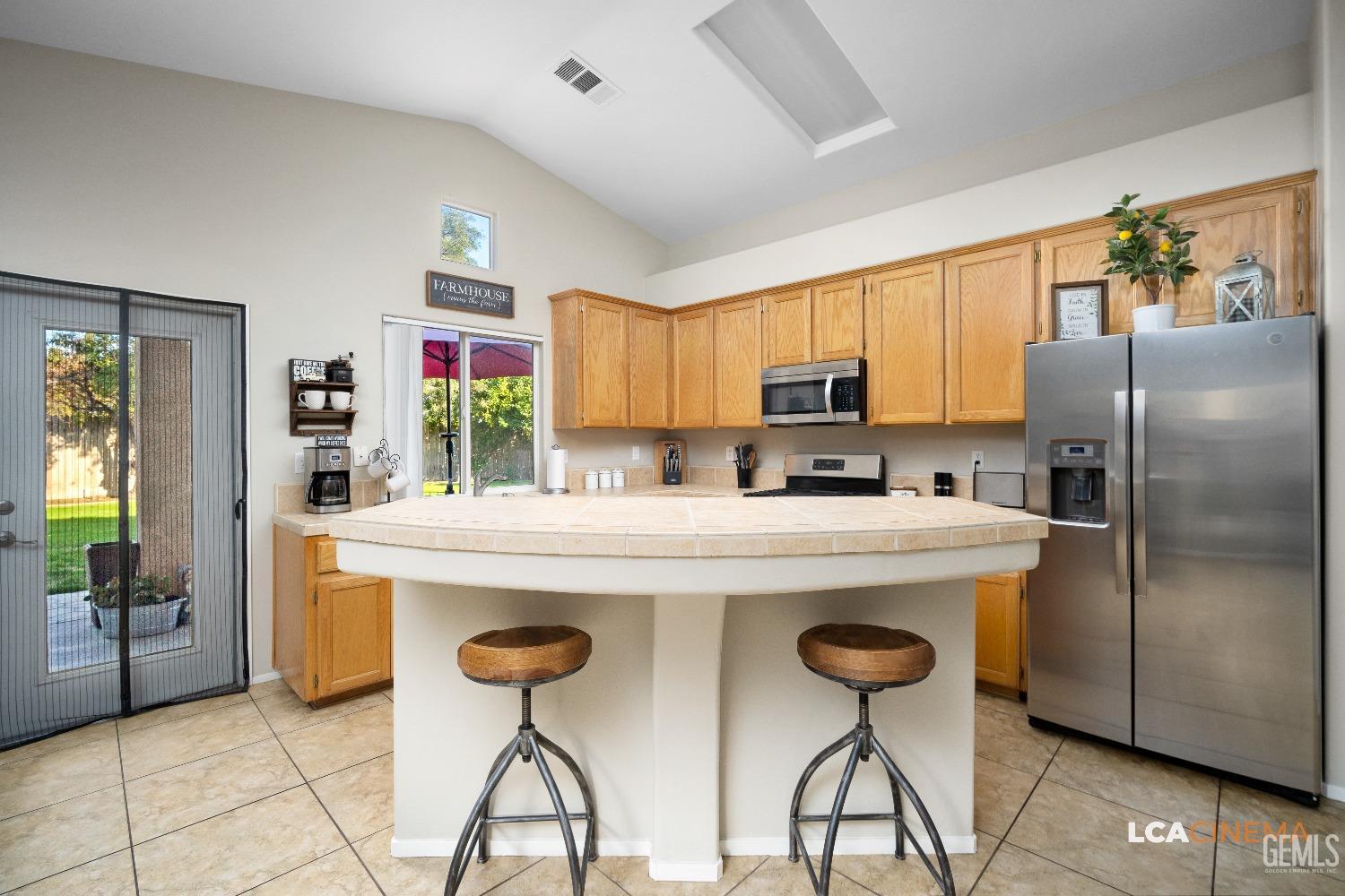 Undisclosed Address Bakersfield, CA 93311 - Photo 8 of 26 a kitchen with stainless steel appliances a stove a refrigerator sink and cabinets