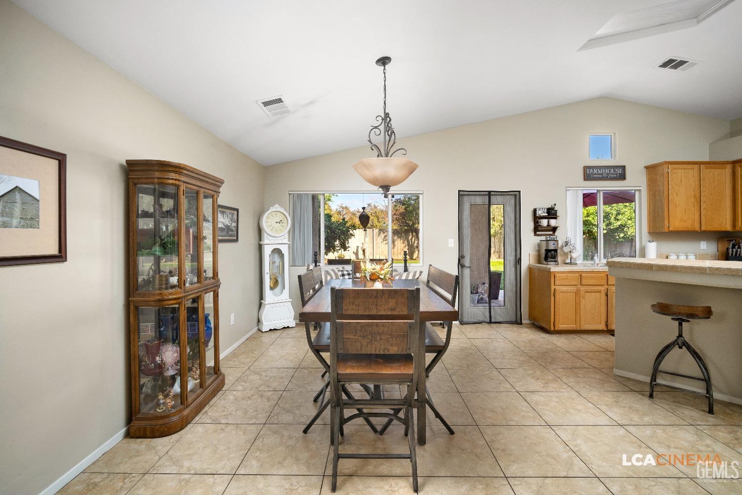 Undisclosed Address Bakersfield, CA 93311 - Photo 9 of 26 a living room with furniture a dining table and a chandelier