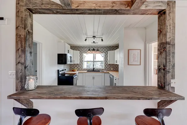 a view of a kitchen with granite countertop a counter top space and stainless steel appliances