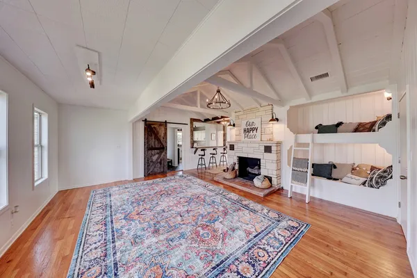 a view of a livingroom with fireplace and cabinet