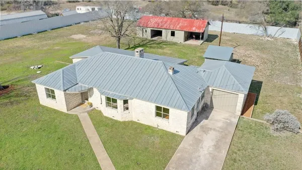 an aerial view of a house with outdoor space