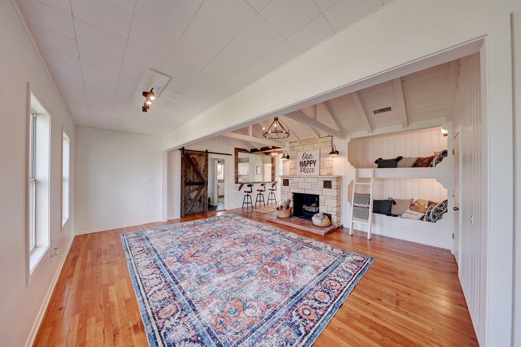 102 Myrtle Avenue Harper, TX 78631 - Photo 22 of 49 a bed room with a bed and a fireplace