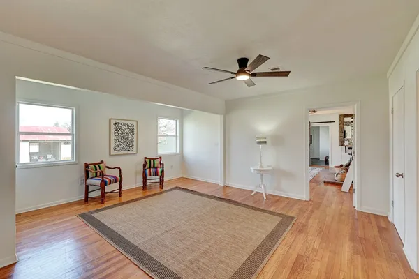 a living room with furniture and wooden floor