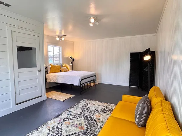 a bedroom with a bed and dresser