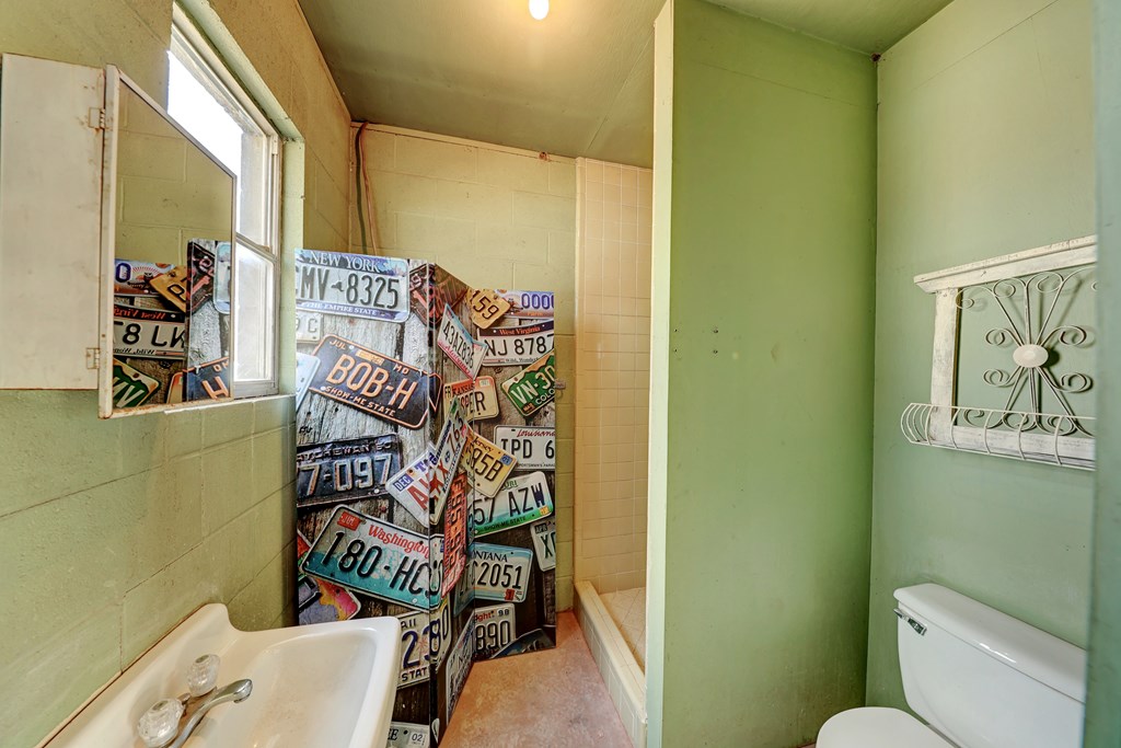 102 Myrtle Avenue Harper, TX 78631 - Photo 44 of 49 a bathroom with a toilet and a shower curtain