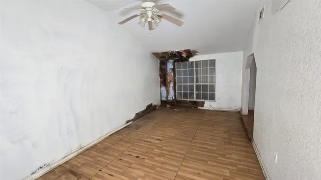 a view of a kitchen with wooden floor and electronic appliances