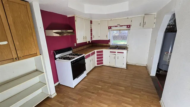 a kitchen with stainless steel appliances a stove a refrigerator and a refrigerator