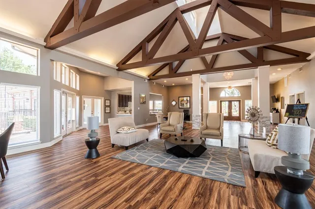 a living room with furniture a fireplace and a table