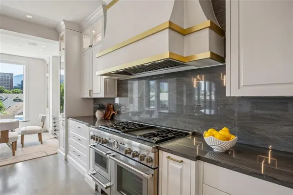 a stove top oven sitting inside of a kitchen