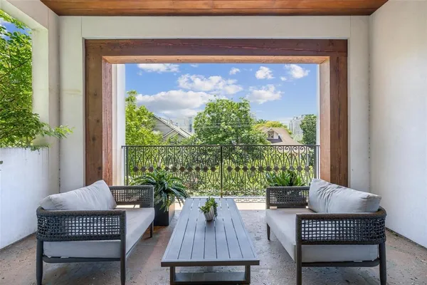 a outdoor living room with furniture and a potted plant