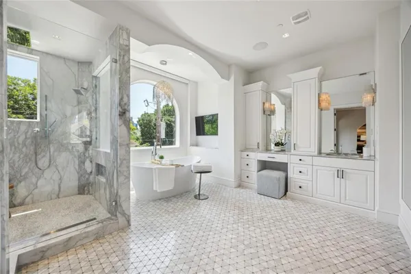 a large bathroom with a double vanity sink a toilet a mirror and shower