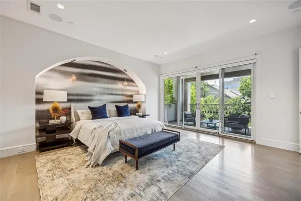 a bedroom with a bed and large window