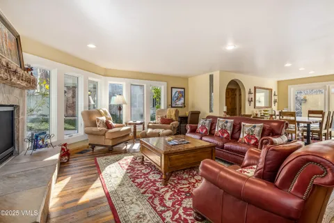 a living room with furniture fireplace and a window