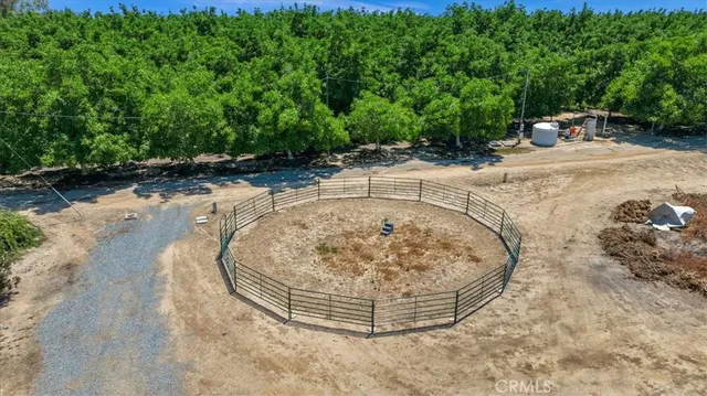 a view of a lake with a table and chairs under an umbrella