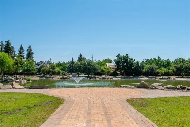 a kitchen with stainless steel appliances granite countertop a stove refrigerator sink and microwave
