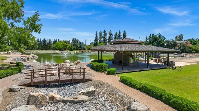 a kitchen with granite countertop a stove sink and cabinets