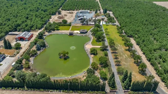 an aerial view of a residential houses with outdoor space and swimming pool