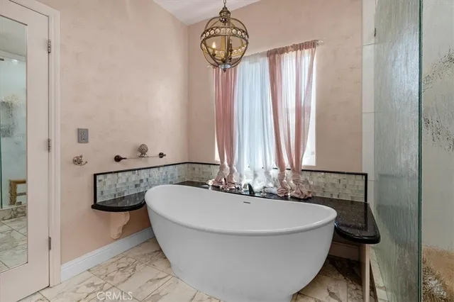 a front view of a house with a garden and trees