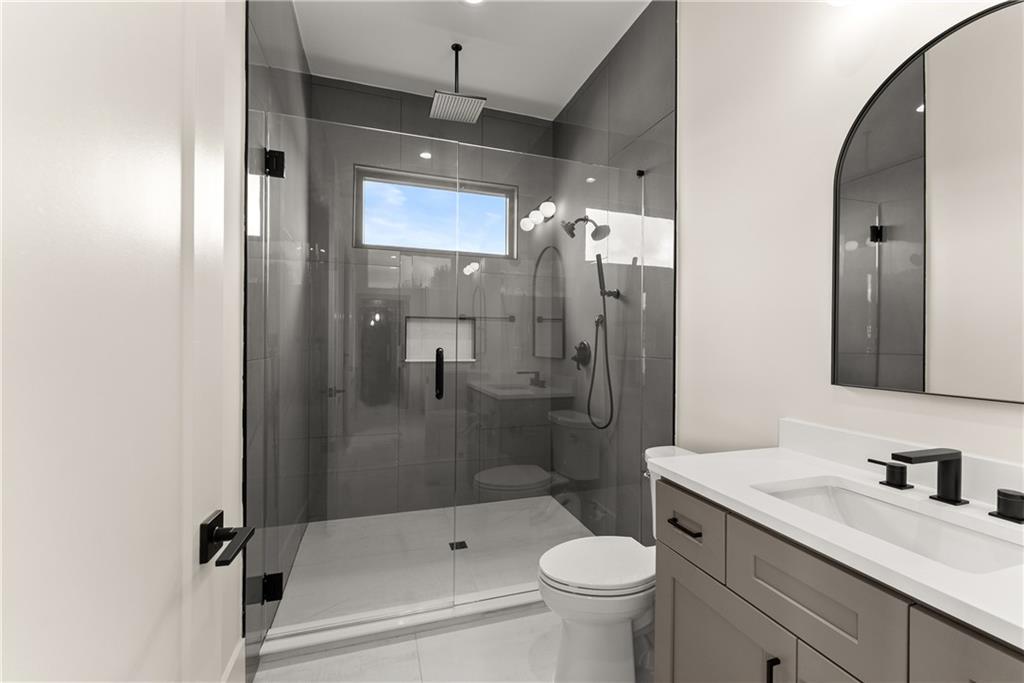 2021 Jones Phillips Road Dacula, GA 30019 - Photo 13 of 65 a bathroom with a sink a toilet and shower