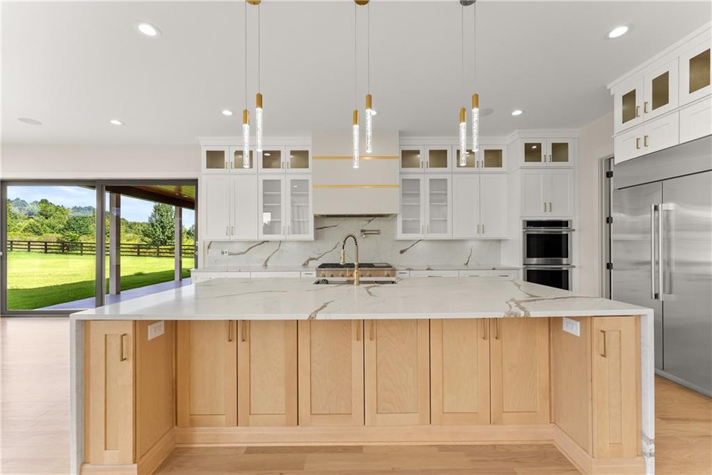 2021 Jones Phillips Road Dacula, GA 30019 - Photo 16 of 65 a view of a kitchen with kitchen island a sink stainless steel appliances and cabinets