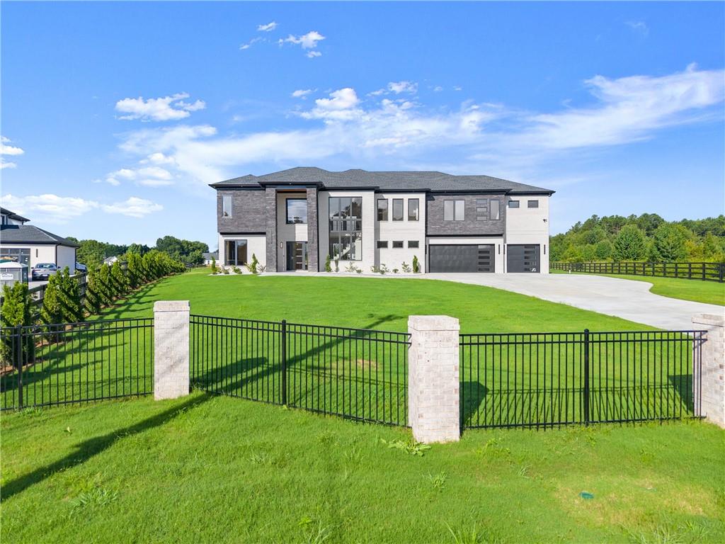 2021 Jones Phillips Road Dacula, GA 30019 - Photo 21 of 65 a view of a garden with a house in the background