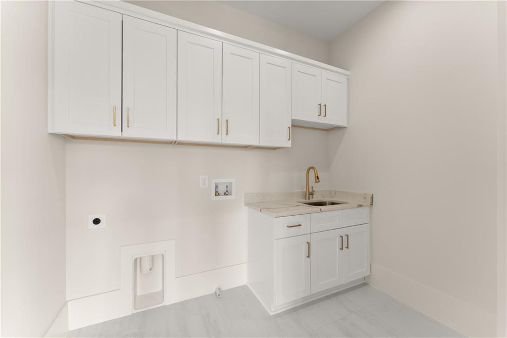 2021 Jones Phillips Road Dacula, GA 30019 - Photo 36 of 65 a kitchen with white cabinets and a sink