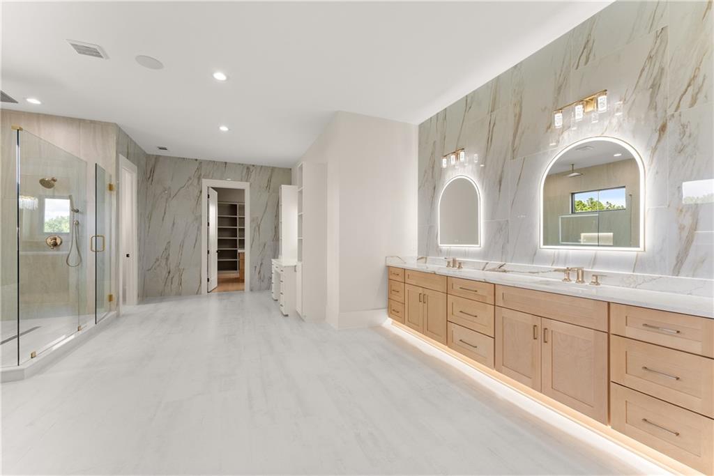 2021 Jones Phillips Road Dacula, GA 30019 - Photo 44 of 65 a spacious bathroom with a double vanity sink and a mirror
