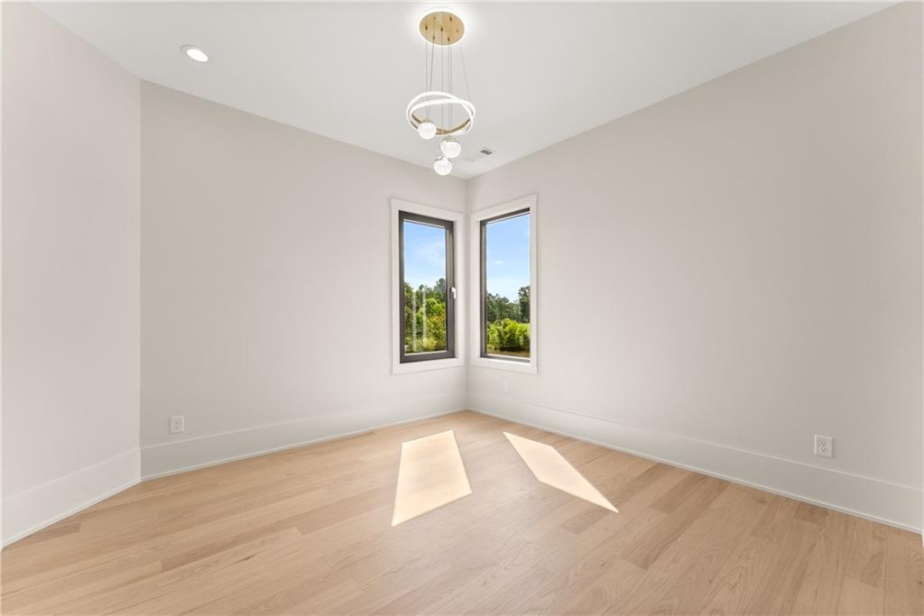 2021 Jones Phillips Road Dacula, GA 30019 - Photo 51 of 65 an empty room with windows and outdoor view
