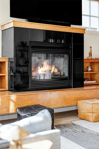 a living room with a fireplace and a flat screen tv