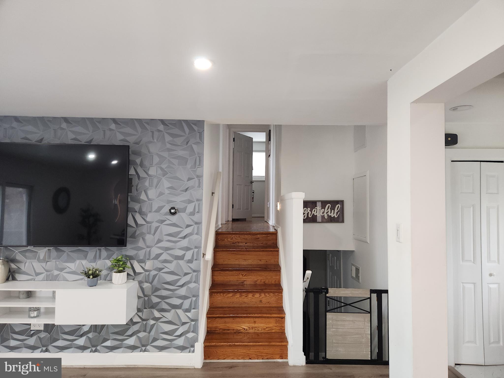 1170 South Trooper Road Norristown, PA 19403 - Photo 6 of 45 a view of a hallway with wooden floor and a living room