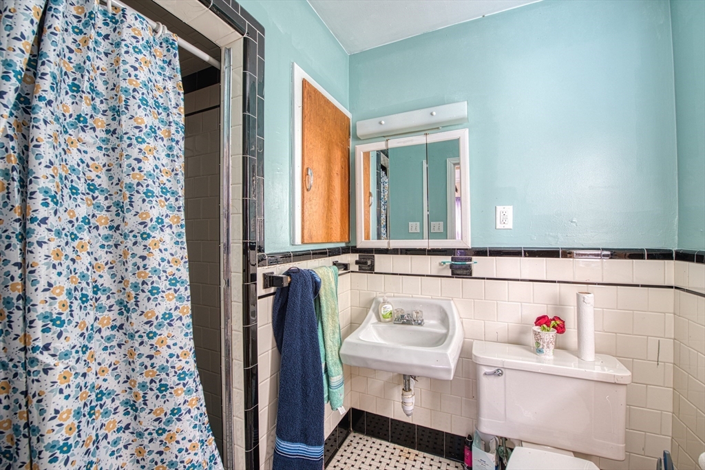499 Maple Street Fall River, MA 02720 - Photo 12 of 21 a bathroom with a sink and a mirror