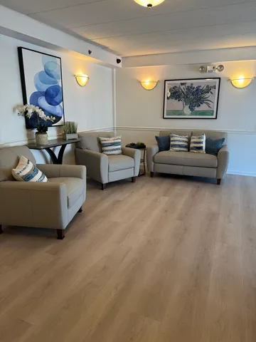 a living room with furniture and a mirror