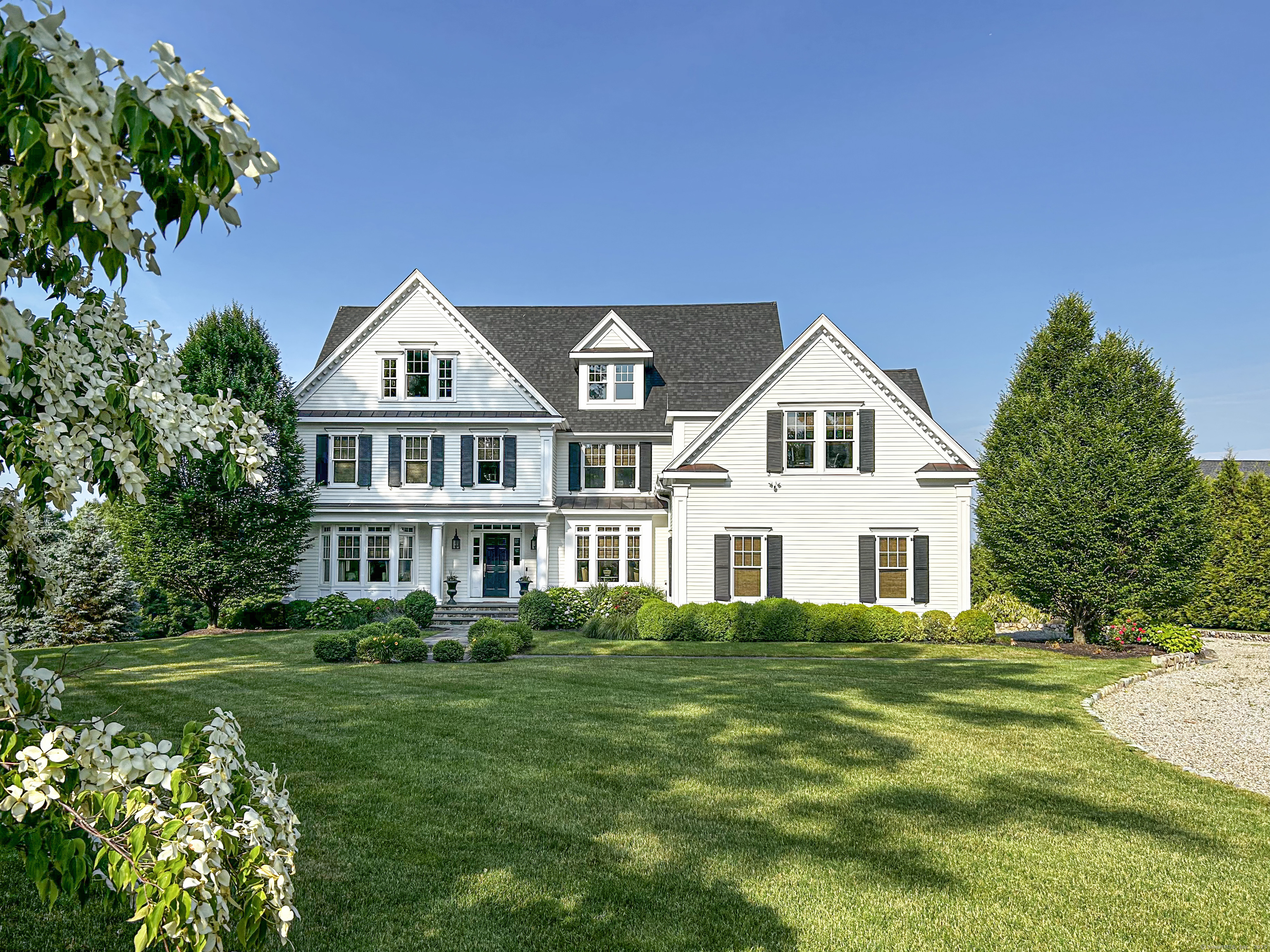277 Ridgebury Road Ridgefield, CT 06877 - Photo 1 of 1 a front view of a house with a garden