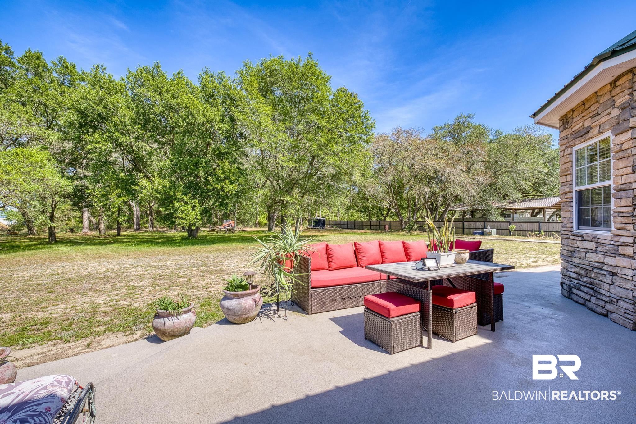 32875 Faircloth Road Lillian, AL 36549 - Photo 53 of 85 Fenced backyard with a patio and outdoor lounge area