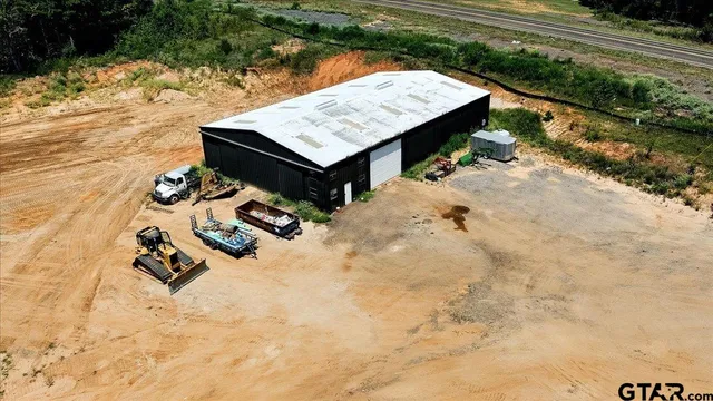 a kitchen with granite countertop a refrigerator a stove and white cabinets